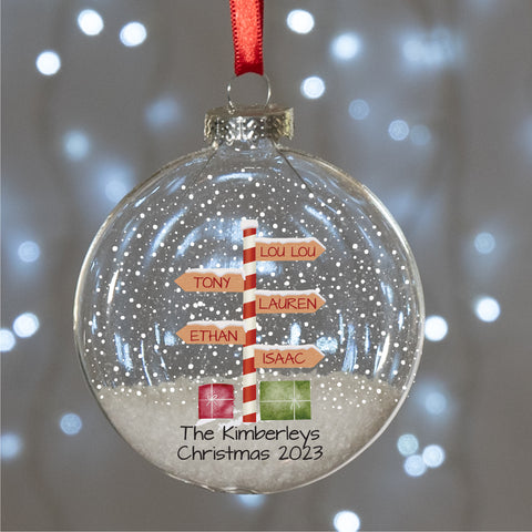 round glass bauble with a striped North Pole sign personalised with family names and message